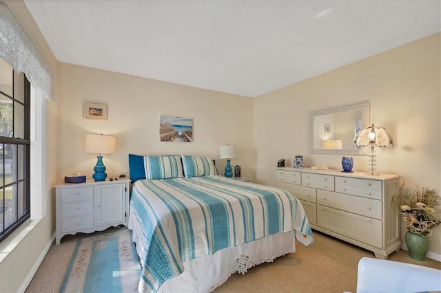 bedroom featuring multiple windows, light carpet, and a textured ceiling