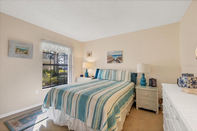 carpeted bedroom featuring a textured ceiling