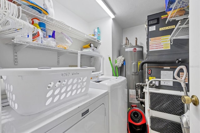 laundry area featuring electric water heater, independent washer and dryer, and heating unit