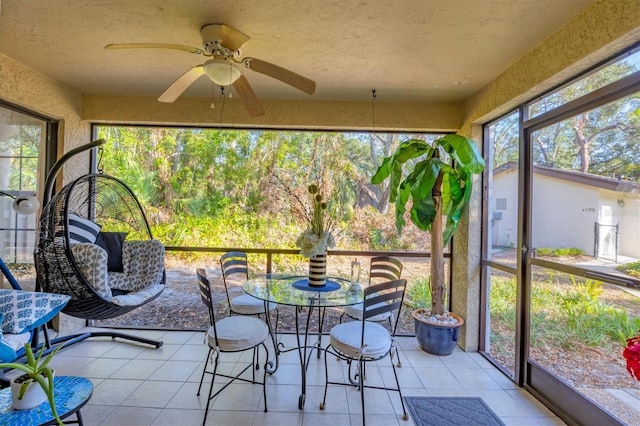 sunroom / solarium featuring ceiling fan