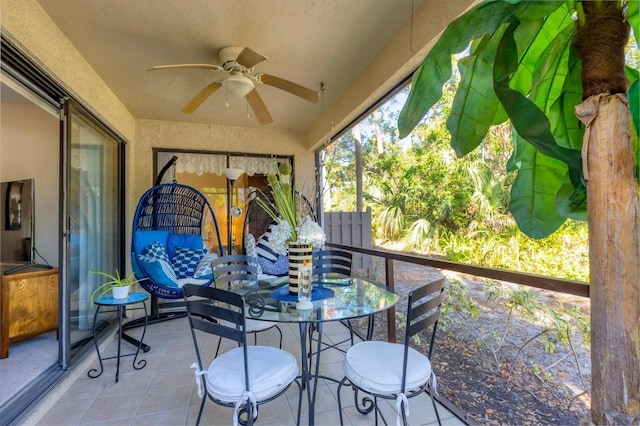 sunroom featuring ceiling fan