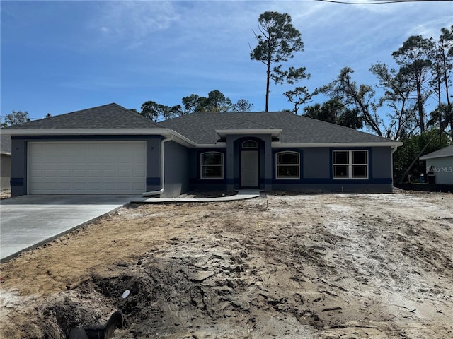 ranch-style house with an attached garage, a shingled roof, concrete driveway, and stucco siding