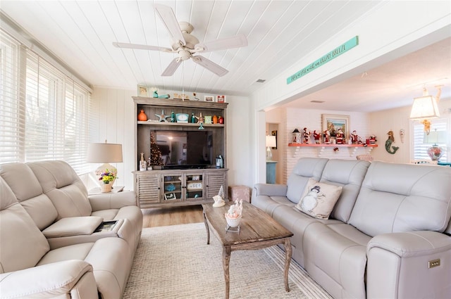 living room featuring light hardwood / wood-style flooring, ceiling fan, and wooden ceiling