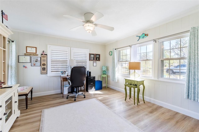 office featuring light hardwood / wood-style floors, ceiling fan, and ornamental molding