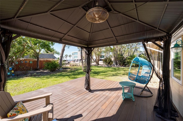 wooden deck featuring a gazebo and a lawn