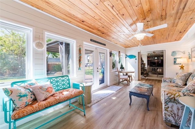 sunroom / solarium featuring french doors, ceiling fan, and wooden ceiling