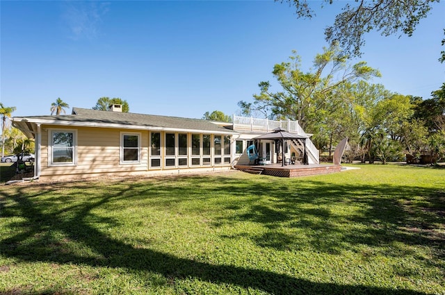 rear view of property with a yard