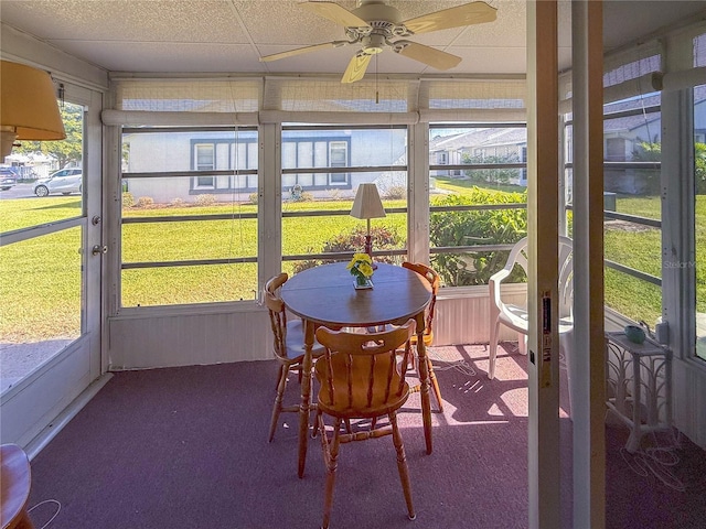 sunroom / solarium featuring ceiling fan and a drop ceiling