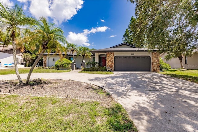 ranch-style home with a front lawn and a garage