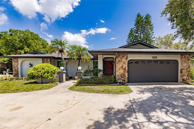 7707 10th Ave NW, Bradenton, FL 34209 - single story home with stone siding, concrete driveway, and an attached garage