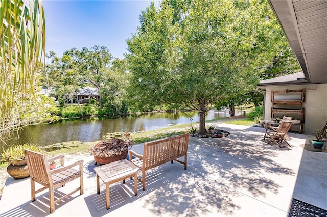 7707 10th Ave NW, Bradenton, FL 34209 - view of patio / terrace with an outdoor fire pit and a water view