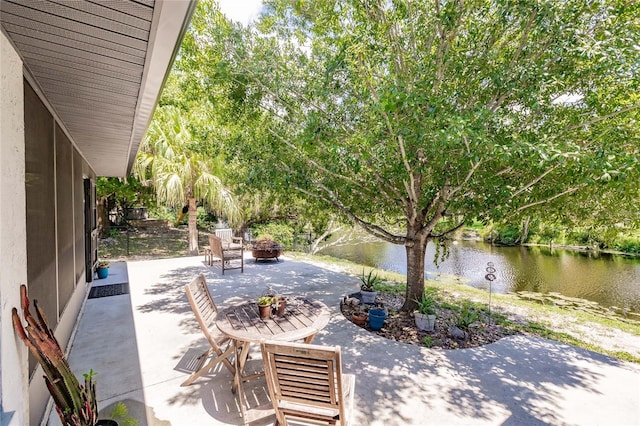 7707 10th Ave NW, Bradenton, FL 34209 - view of patio / terrace with a fire pit and a water view