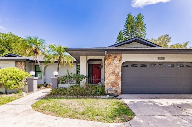 7707 10th Ave NW, Bradenton, FL 34209 - ranch-style home with stone siding, driveway, and an attached garage