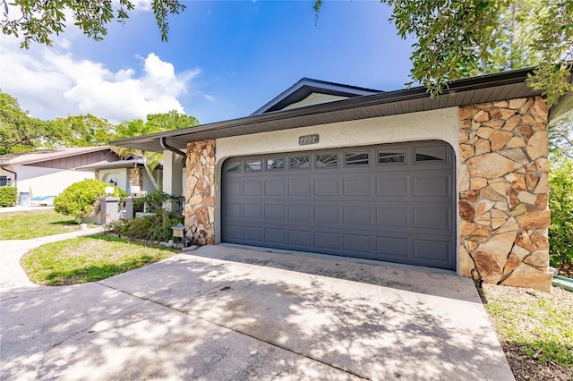 7707 10th Ave NW, Bradenton, FL 34209 - single story home featuring stone siding, driveway, an attached garage, and stucco siding