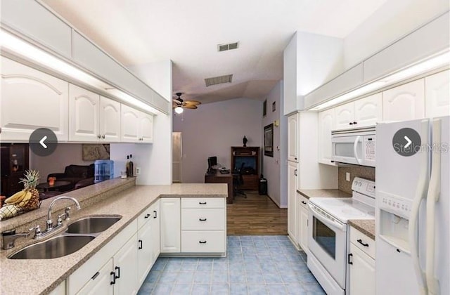 kitchen with ceiling fan, sink, kitchen peninsula, white appliances, and white cabinets