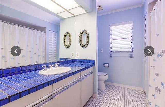 7707 10th Ave NW, Bradenton, FL 34209 - full bath with toilet, vanity, crown molding, tile patterned floors, and baseboards