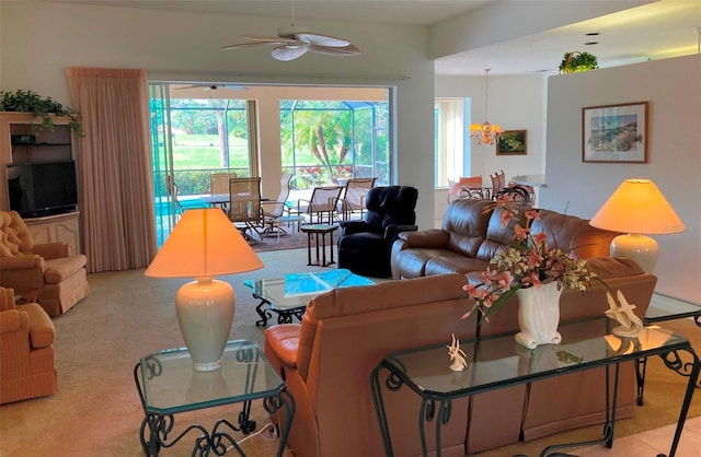 living room with light carpet and ceiling fan with notable chandelier