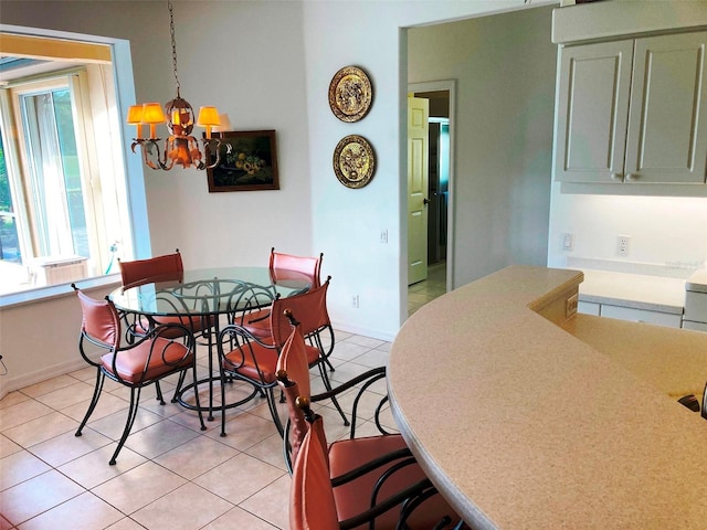 dining area featuring light tile patterned floors and a notable chandelier