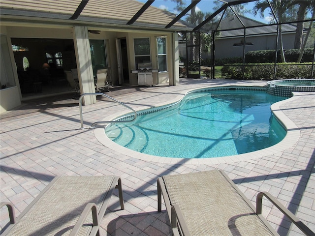 view of pool featuring a patio area, a lanai, and an in ground hot tub