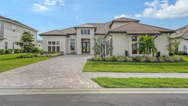 view of front of home with french doors and a front lawn