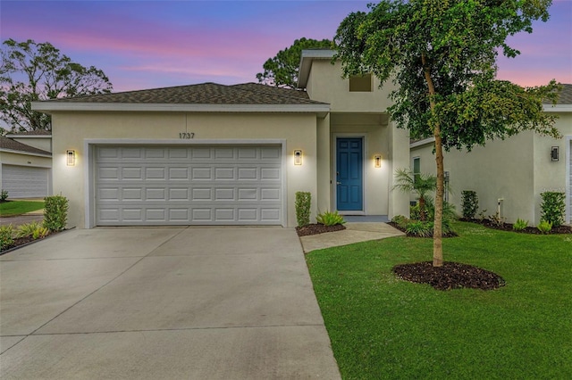 view of front of house featuring a garage and a yard