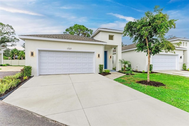 view of front facade featuring a front yard and a garage