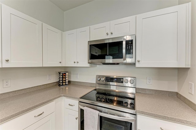 kitchen featuring white cabinets and appliances with stainless steel finishes