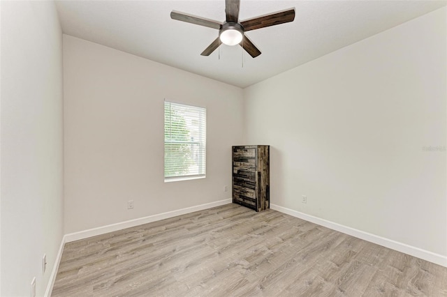 empty room with ceiling fan and light hardwood / wood-style floors