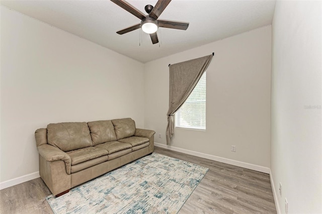 living room with hardwood / wood-style flooring and ceiling fan