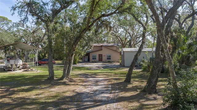 view of front of home with an outbuilding and a front yard