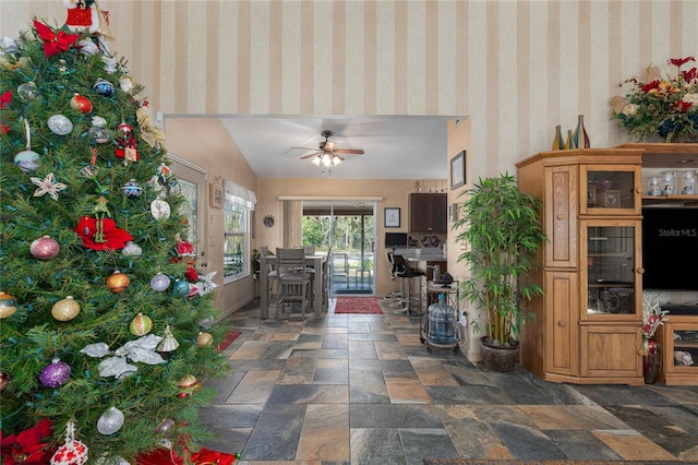 unfurnished living room with ceiling fan