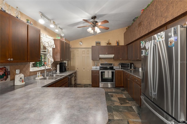 kitchen featuring ceiling fan, sink, stainless steel appliances, tasteful backsplash, and lofted ceiling