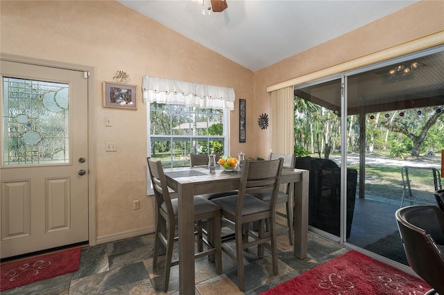 dining space with ceiling fan and lofted ceiling