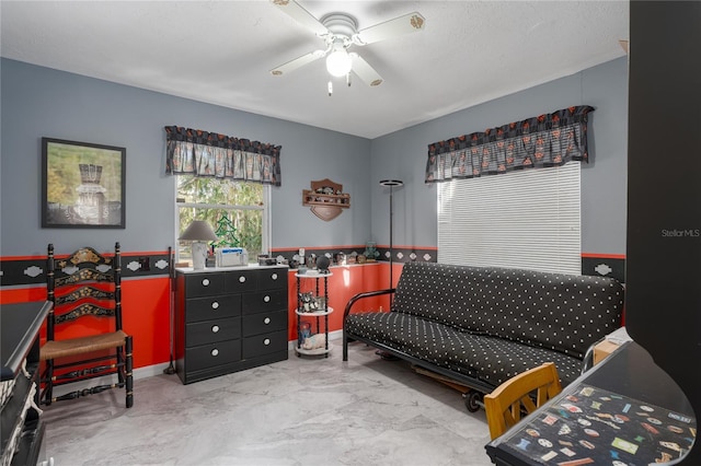 interior space with a textured ceiling and ceiling fan