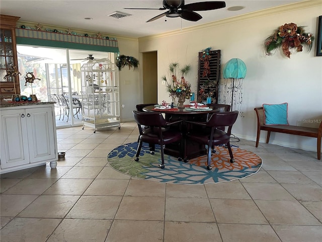 tiled dining room featuring crown molding and ceiling fan