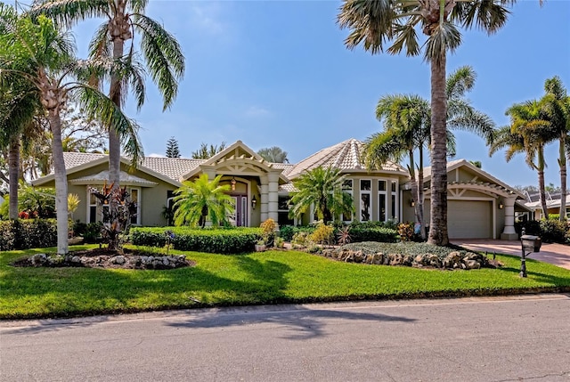 view of front of property featuring a front yard and a garage