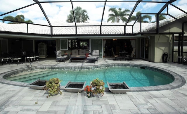 view of swimming pool featuring a lanai, outdoor lounge area, and a patio area