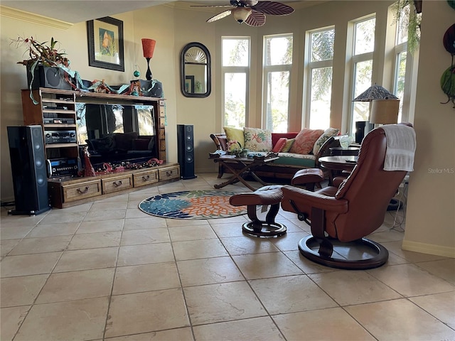 living room with ceiling fan, crown molding, and light tile patterned floors