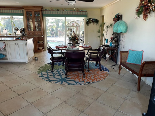 dining room with ceiling fan and ornamental molding