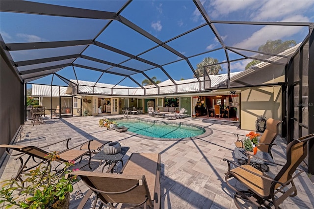 view of pool featuring glass enclosure and a patio area