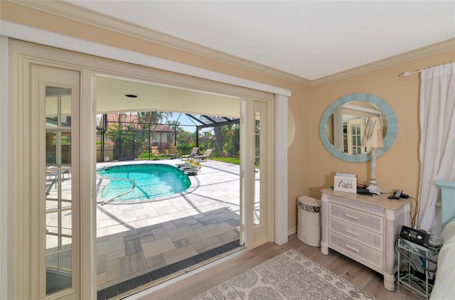 doorway featuring light hardwood / wood-style flooring and ornamental molding