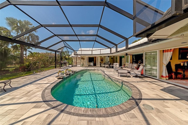 view of swimming pool featuring a lanai, ceiling fan, and a patio