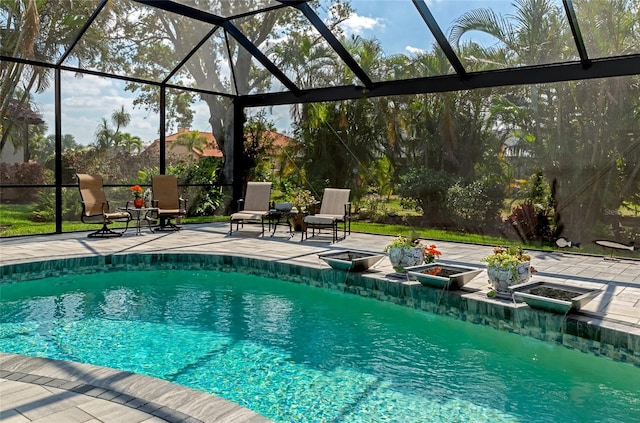 view of pool featuring glass enclosure and a patio area