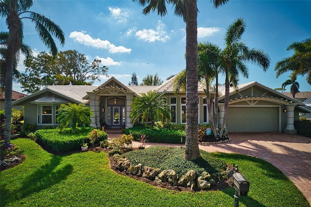 view of front of property featuring a garage and a front lawn