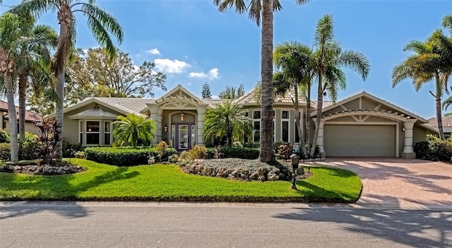 view of front facade with a garage and a front lawn