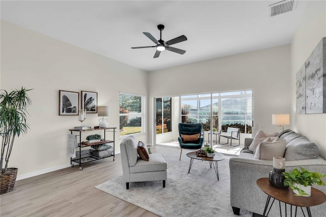 living room featuring light hardwood / wood-style flooring and ceiling fan