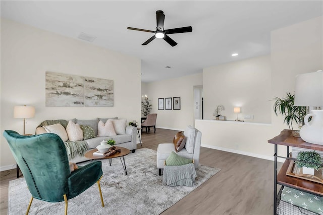 living room featuring hardwood / wood-style floors and ceiling fan