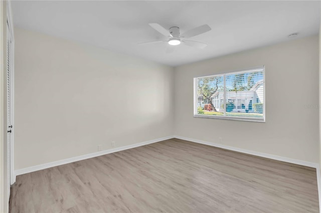 spare room featuring light wood-type flooring and ceiling fan