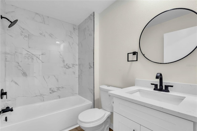 full bathroom featuring tiled shower / bath combo, toilet, and vanity