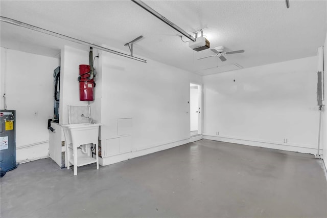 garage featuring electric water heater, sink, ceiling fan, and a garage door opener